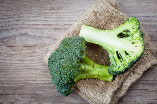 Bunch of fresh green broccoli on wooden background