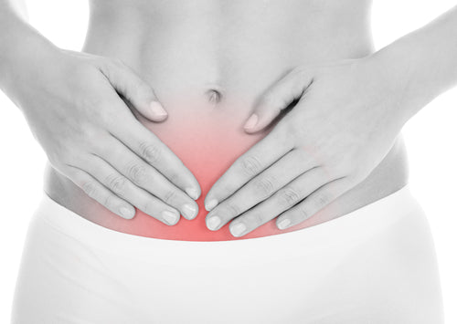 Young Woman With Pain In Her Stomach Isolated Over White Background