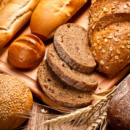 assortment of baked bread on wood table